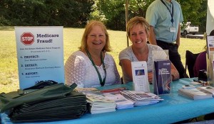 Westbay staff manning an information table at a farmers' market.