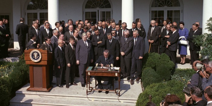 President Johnson signs the Poverty Bill.